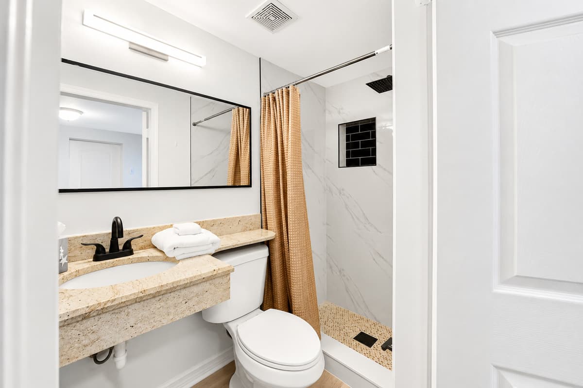 Bedroom 2 - Ensuite
Private ensuite bathroom connected to the family suite, offering a vanity, shower, and convenient access for guests.