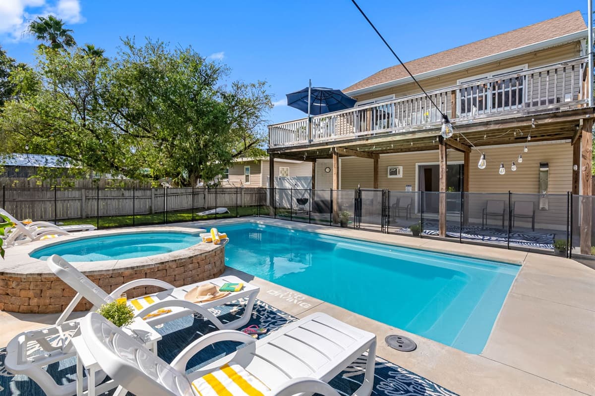 Spend sunny days lounging poolside and enjoy peaceful evenings on the upper deck — this backyard is built for comfort and connection.