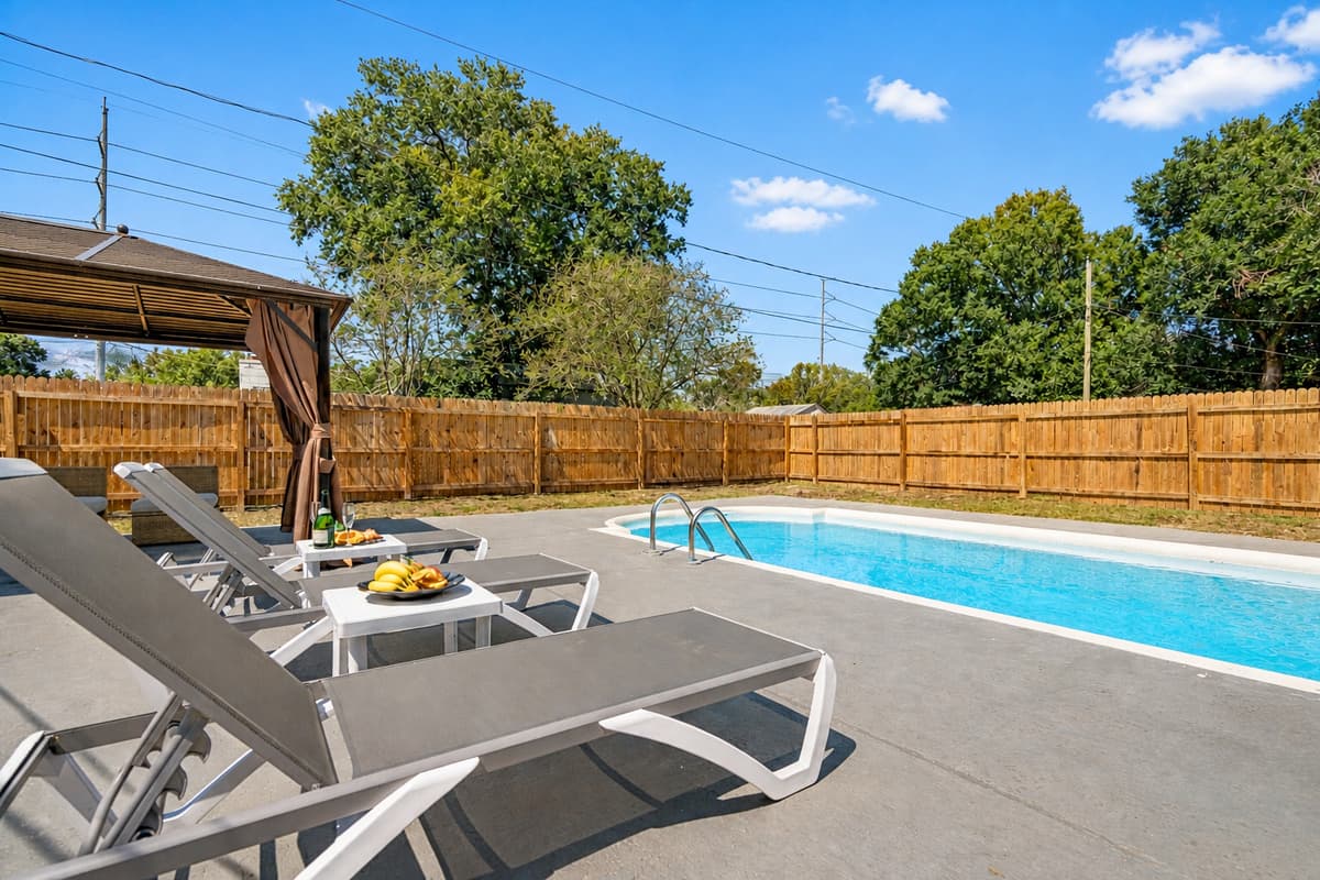 Lounge chairs are dotted near the pool, beckoning you to recline in style and soak up the rays.