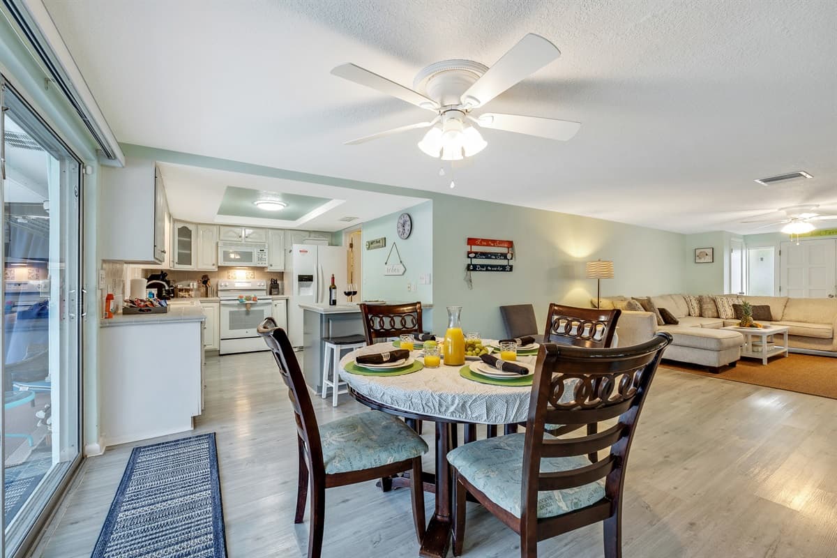 At the heart of this inviting setting is a spacious dining table that comfortably accommodates up to four people.