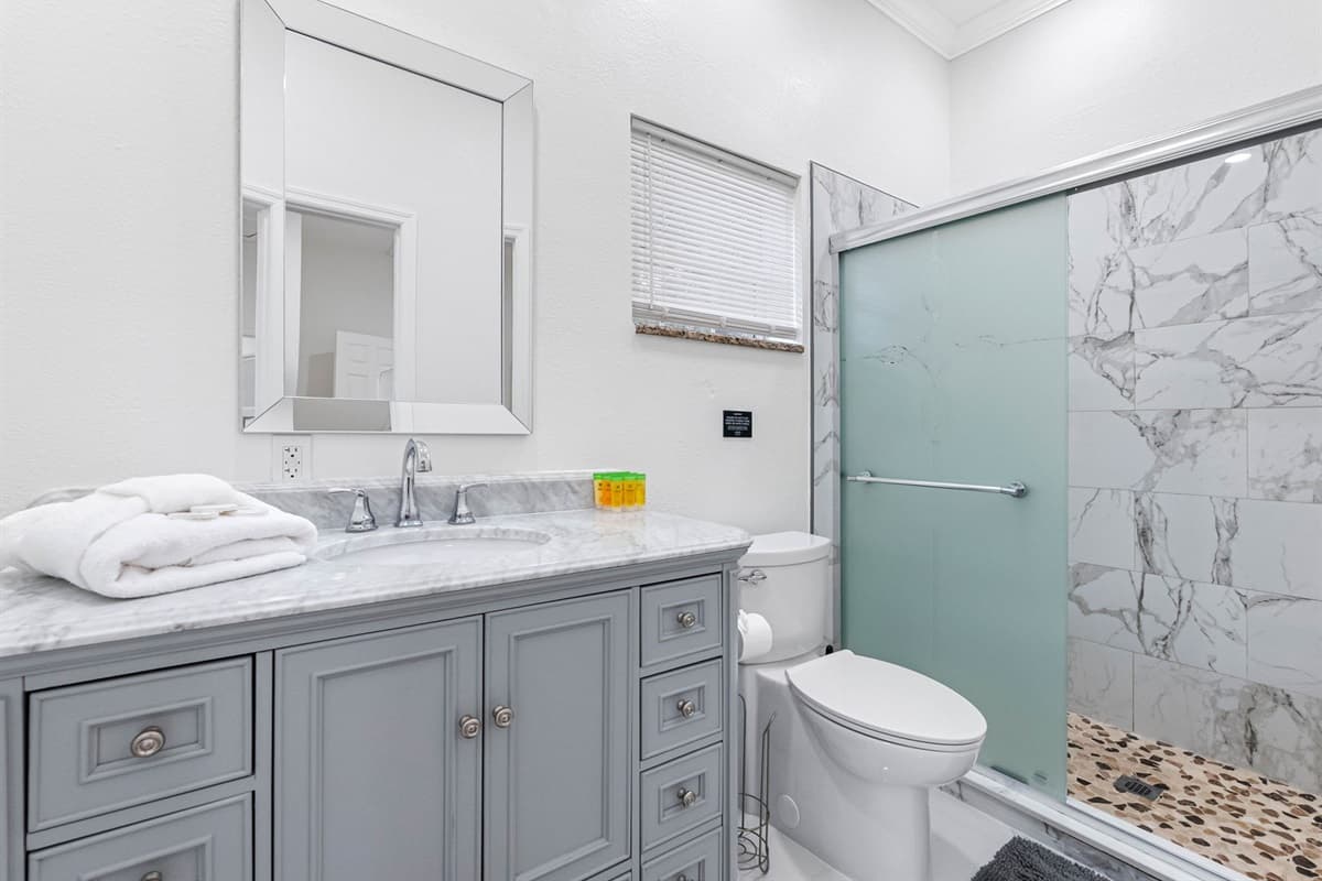 Enjoy a refreshing shower in the stylish walk-in enclosure, complete with premium tilework and modern fixtures designed for comfort and relaxation.