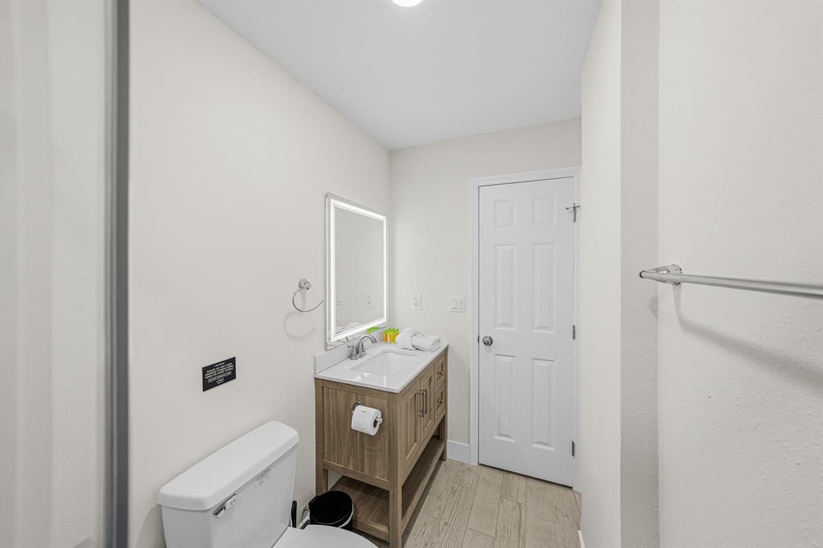 Convenient full bathroom with a spacious vanity and modern finishes.