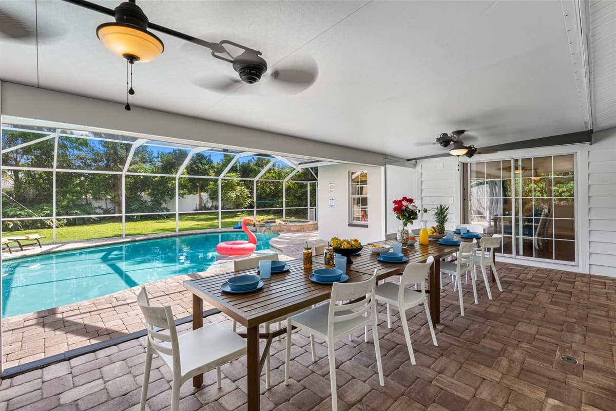 Enjoy year-round relaxation in this screened patio featuring a crystal-clear pool, lounge chairs, and space for family gatherings.