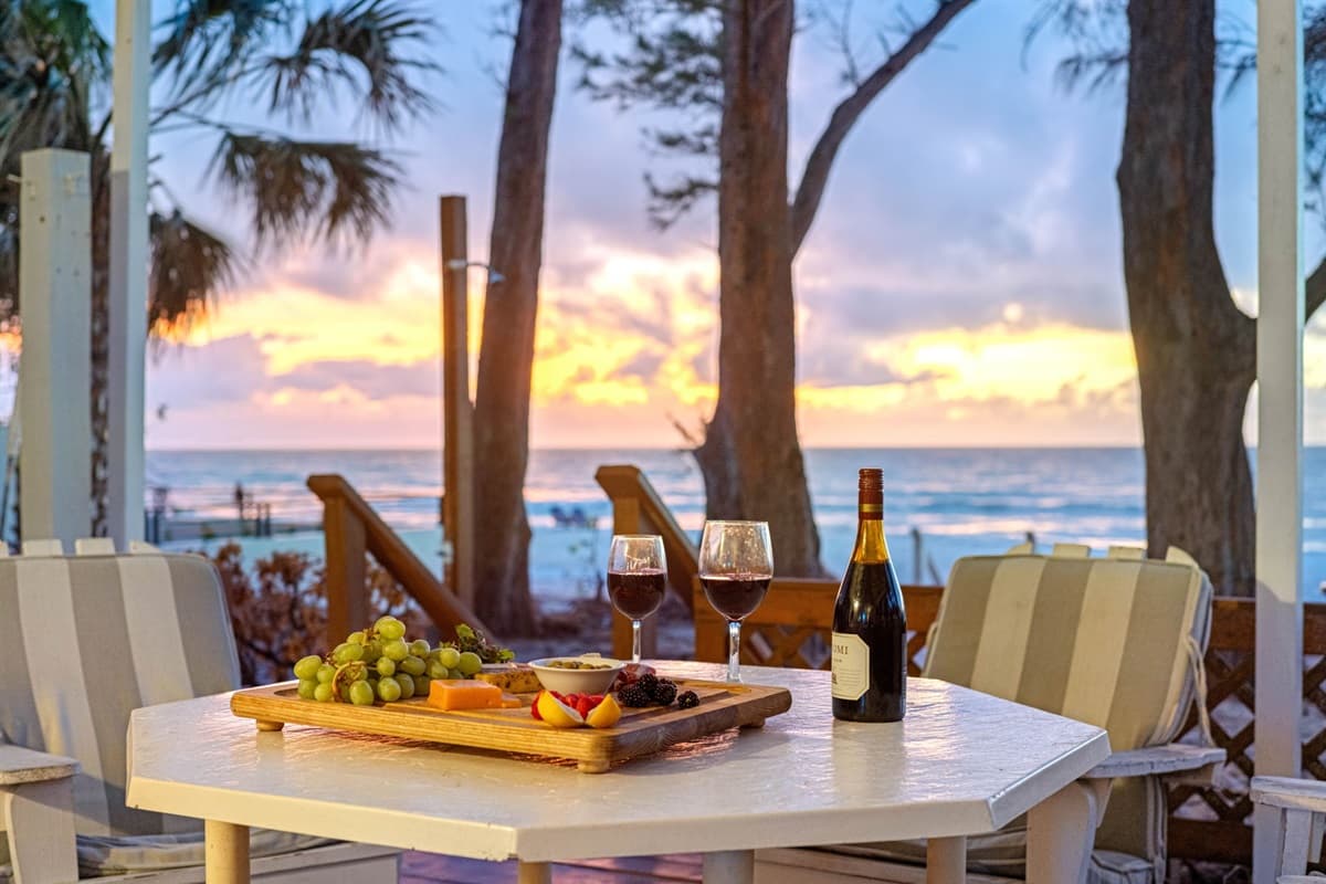 Picture yourself savoring delicious meals with loved ones as the golden hues of the setting sun reflect on the waves, creating a magical and serene ambiance.