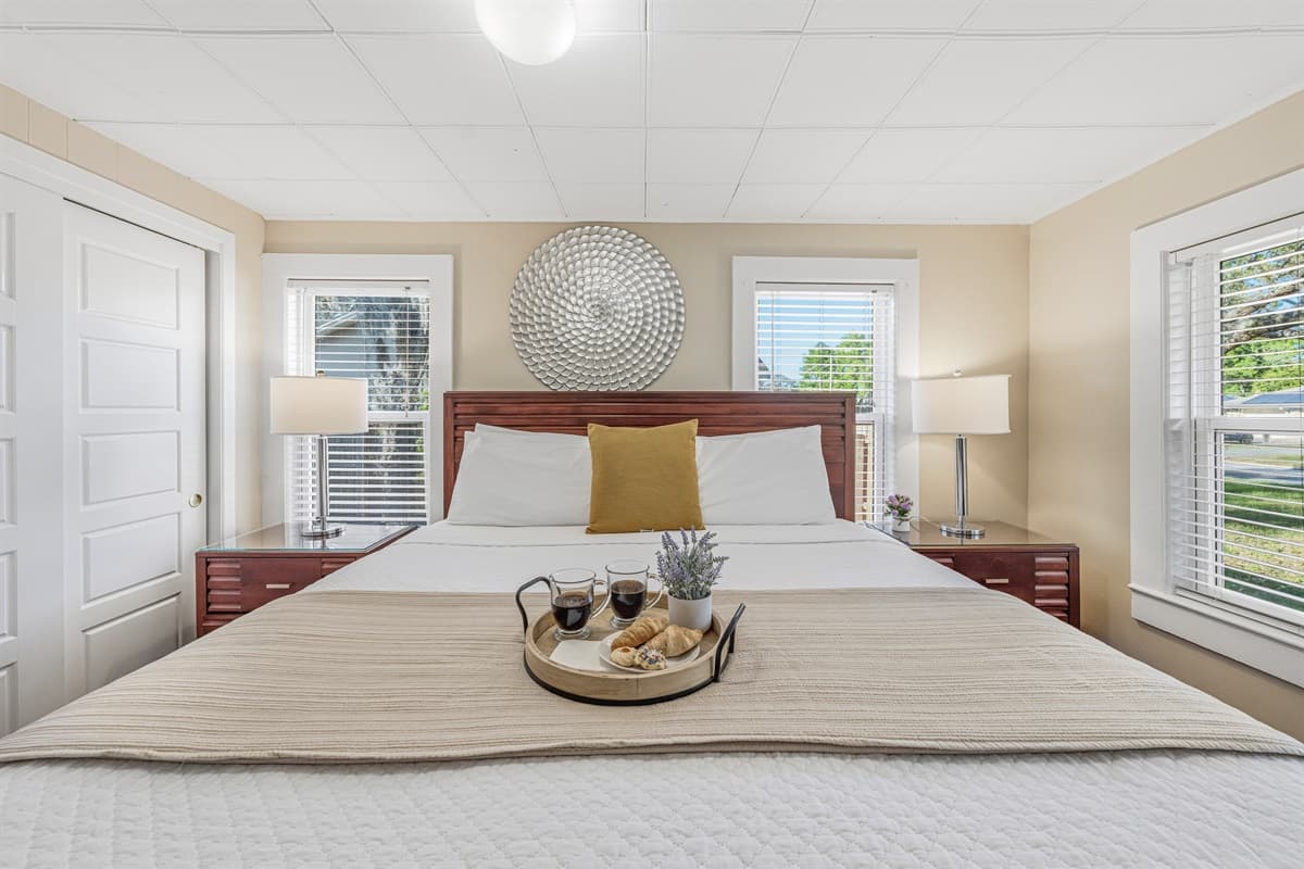 Spacious bedroom with natural light and a clean, relaxing design.