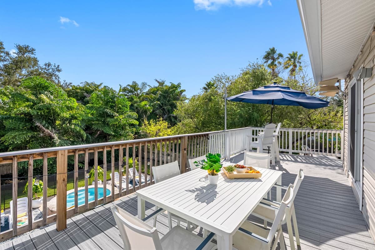 Enjoy meals al fresco on this spacious deck with seating for the whole group and views of the lush greenery below.
