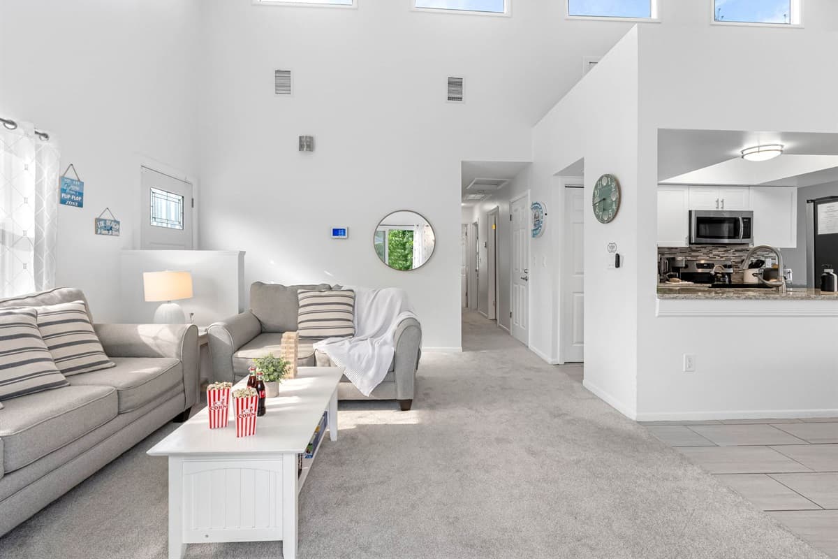 Sunlight fills this open-concept living space, where cozy seating and modern touches create the perfect place to relax with family and friends.