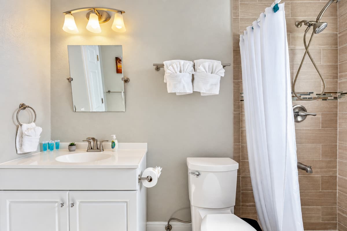 The bathroom features a harmonious blend of functionality and style, boasting contemporary fixtures and tasteful decor.
