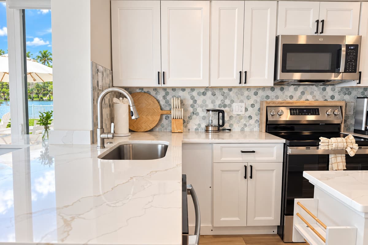 Kitchen with an island, stainless appliances and space to prepare meals.
