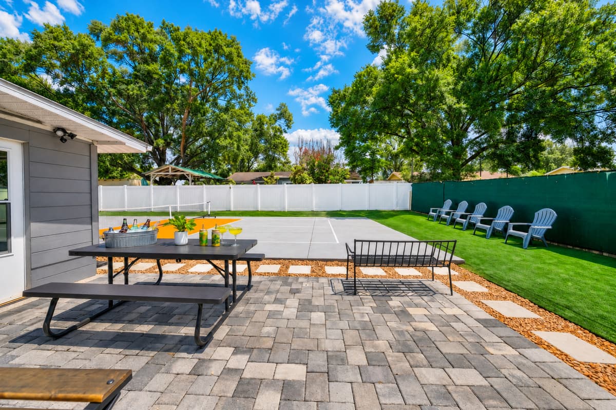 The spacious backyard is designed for fun, featuring a private pickleball court, outdoor seating, and plenty of room to relax in the Florida sunshine.