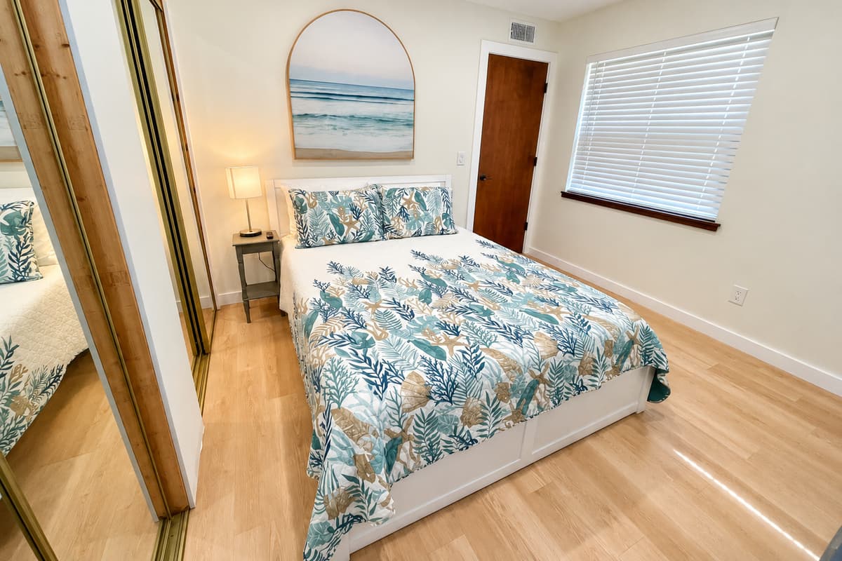 The bed beckons with its plush bedding, ensuring a restful night's sleep. Sink into the softness of the pillows and wrap yourself in the cozy covers.