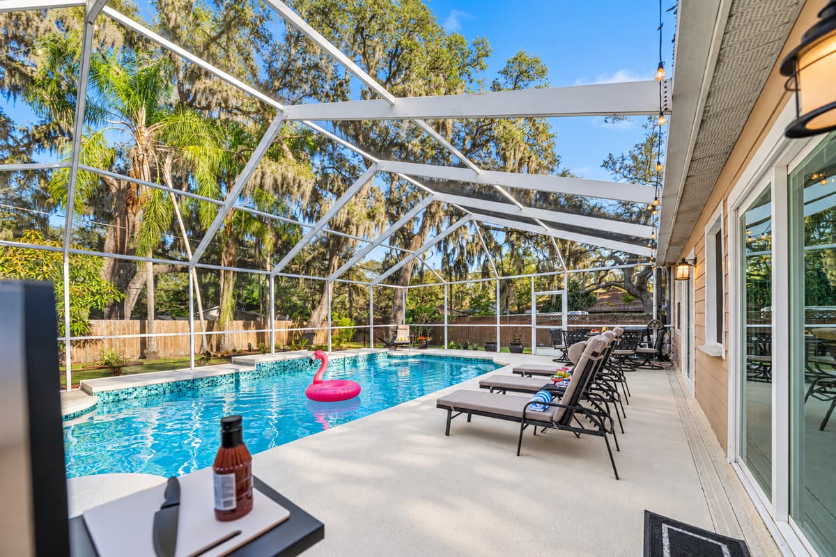 Designed for year-round enjoyment, the screened-in pool area provides privacy, comfort, and relaxation.
