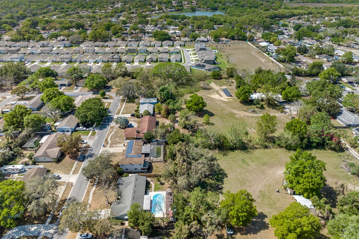 From above, you can appreciate the gentle curves of the tree-lined streets, the spacious yards and gardens, and the charming homes that dot the landscape.