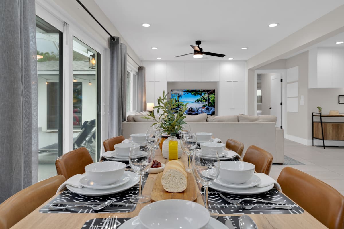 Every detail is set for an inviting dining experience, from elegant glassware to the little touch of greenery.
