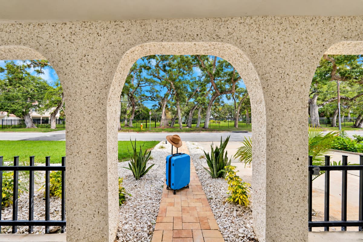 Step through the arches into vacation. The arched front porch frames the oak-lined street. A charming first impression and a shady spot to sit outside.