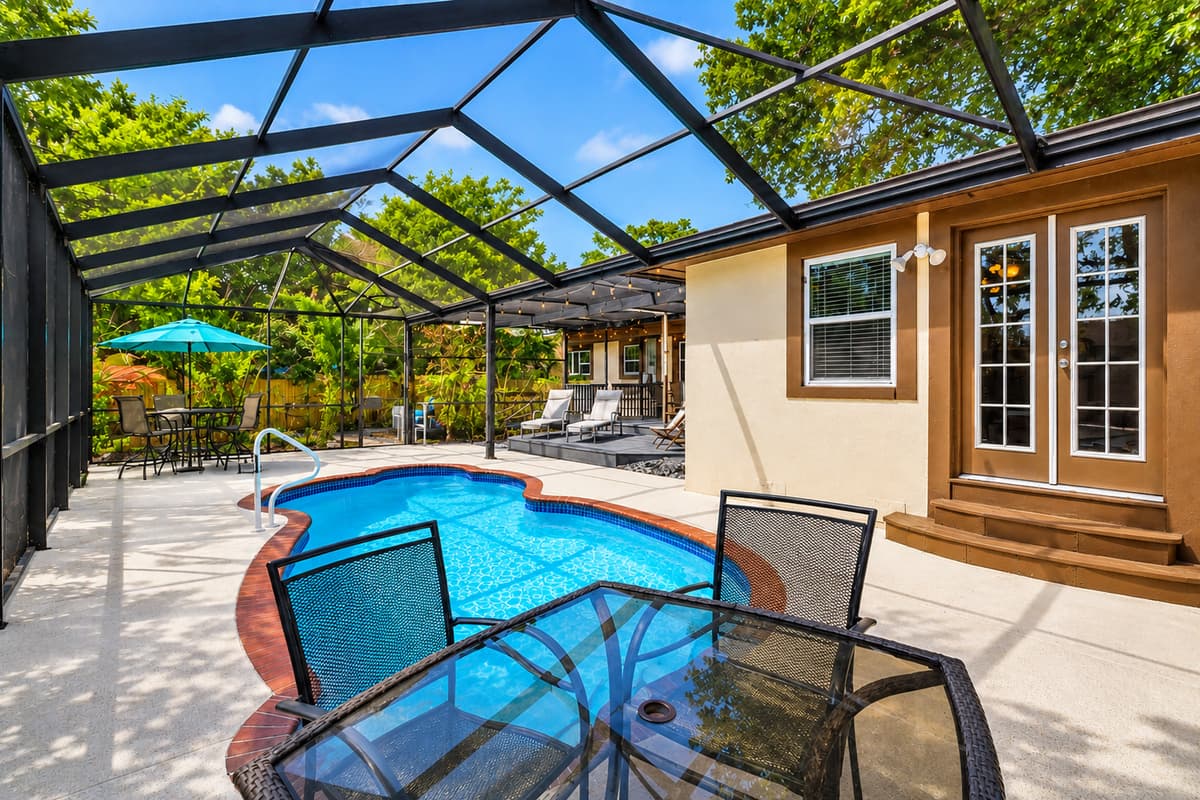Private screened pool area with ample lounge seating and a relaxing resort-style atmosphere.