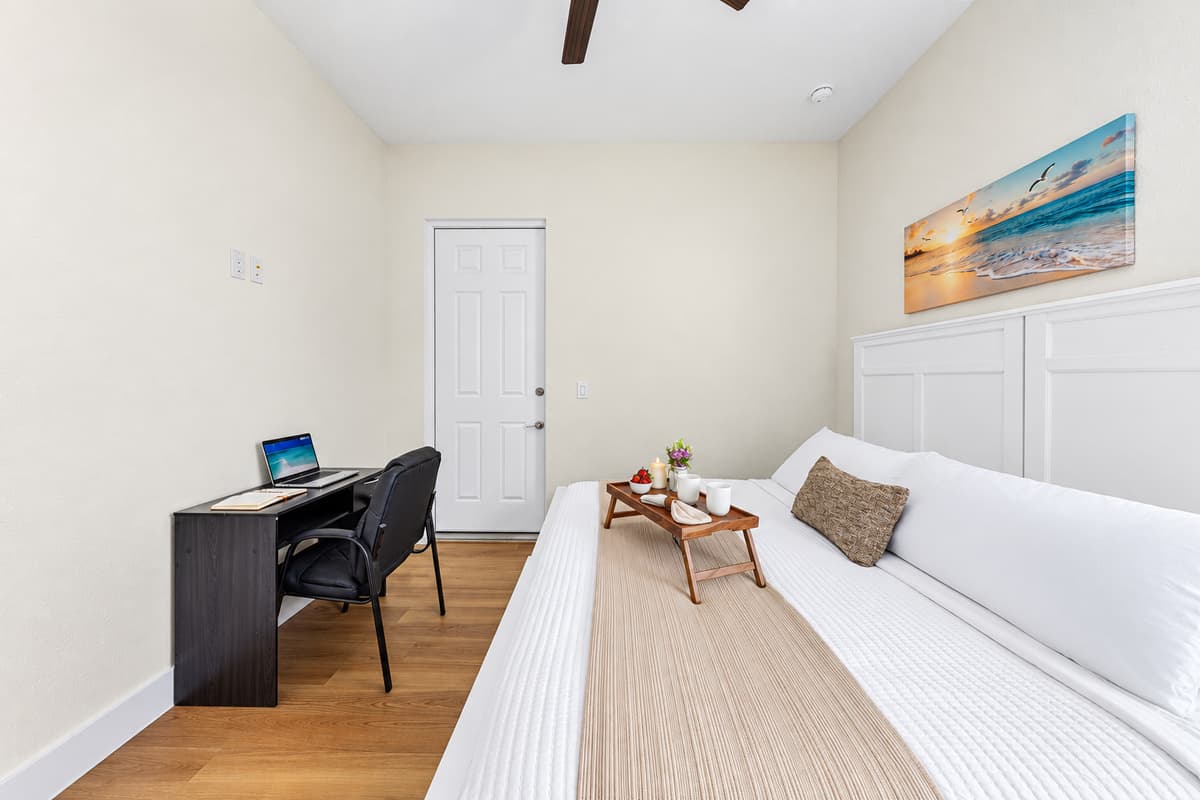 Spacious bedroom with desk setup—ideal for both relaxation and productivity.