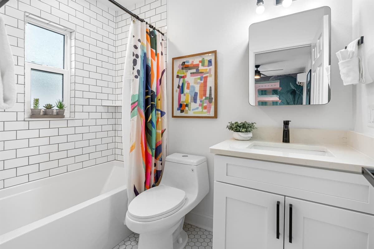 As you enter, you'll be greeted by sleek, modern fixtures and elegant tile work that exude sophistication.