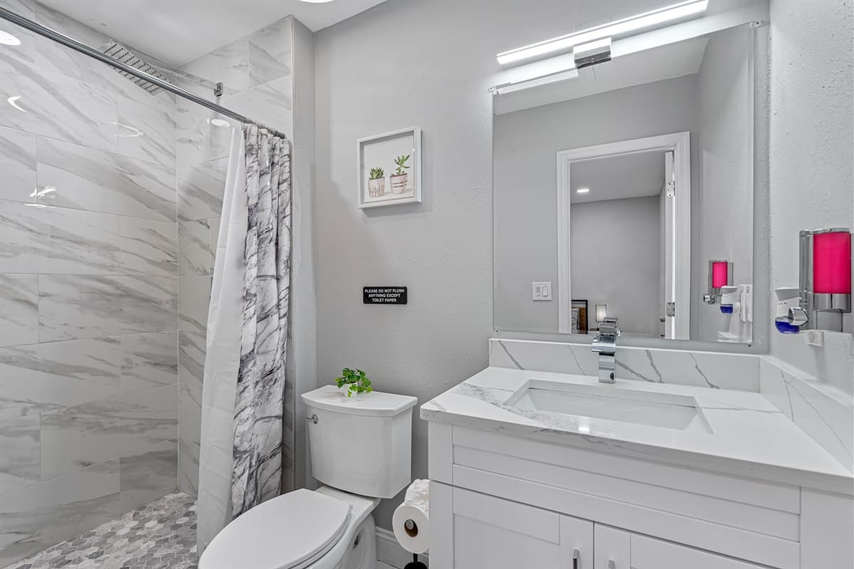 Beautiful bathroom equipped with a sink, toilet, and shower and bathtub combo. Enjoy a relaxing bath after a long day of travel from your home to your home away from home. If you think this property is for you, send us an inquiry right away!