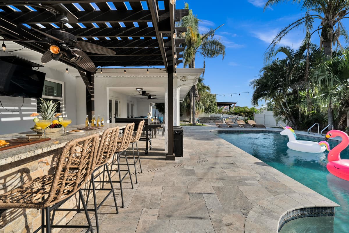Bar stools face the pool directly, so no one has to leave the party to grab a fresh drink