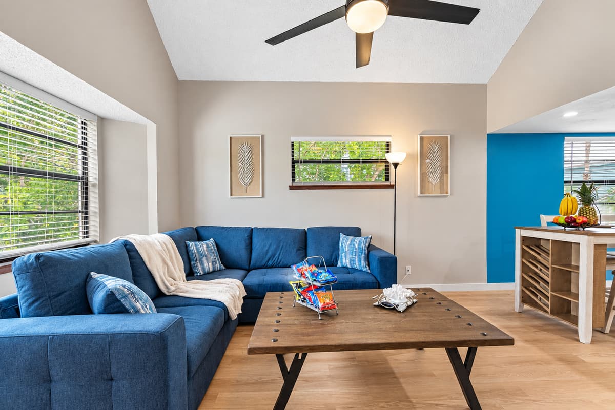 The centerpiece of the room is the exquisite blue sofa, beckoning you to sink into its luxurious cushions and unwind.