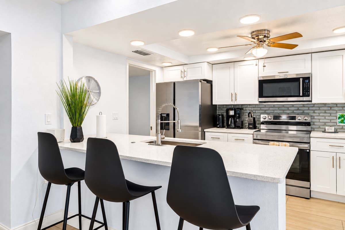 Contemporary kitchen with breakfast bar, stainless steel appliances, and elegant modern finishes.