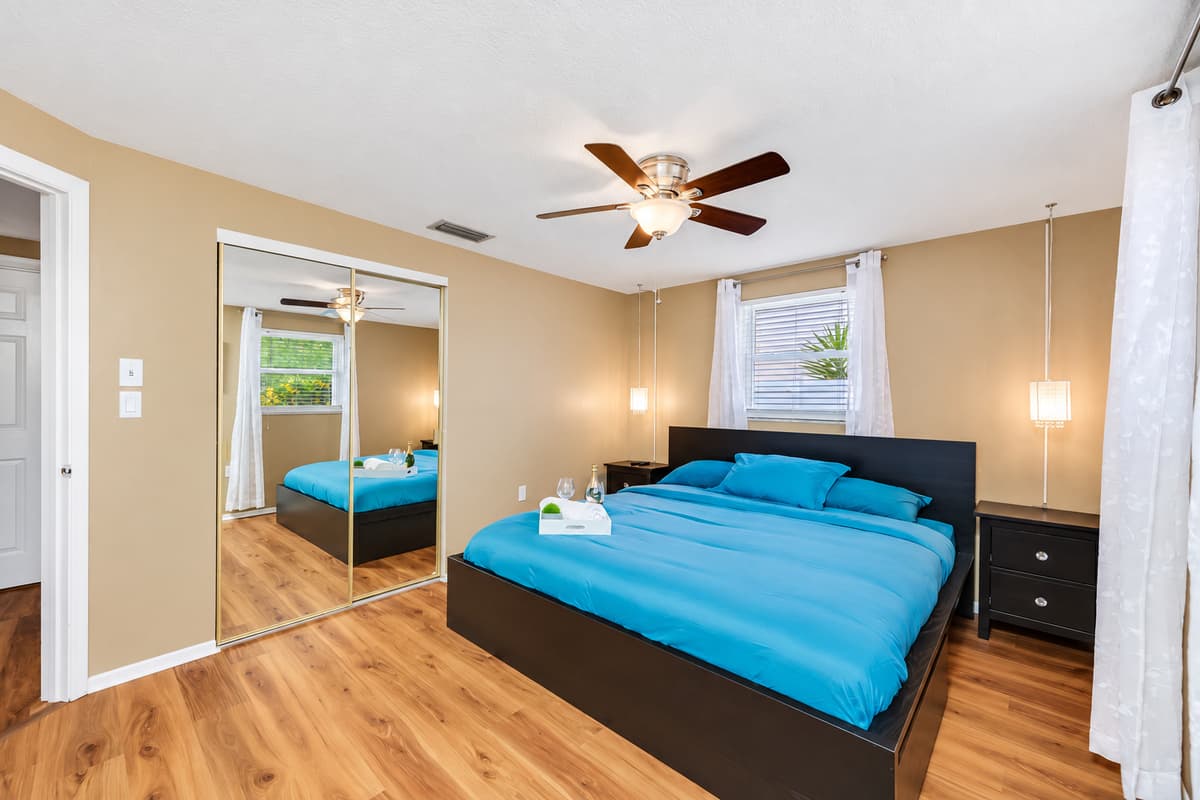 Comfortable bedroom with a king-sized bed, smart TV, and a full-size closet. Sleep safe and sound in the comfort of your home away from home. If you are interested in this property, send us an inquiry right away!