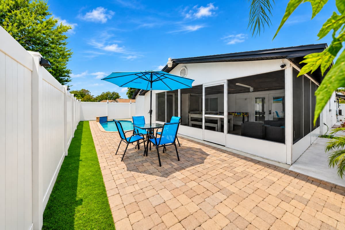Spacious backyard retreat with outdoor dining, private pool access, and plenty of room to relax and soak up Tampa's beautiful weather.