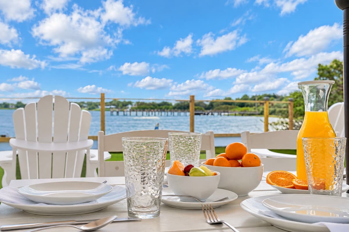 Breakfast with a bay view. Fresh fruit, orange juice and the water right in front of you. Start the day at the patio table and let the morning take its time.