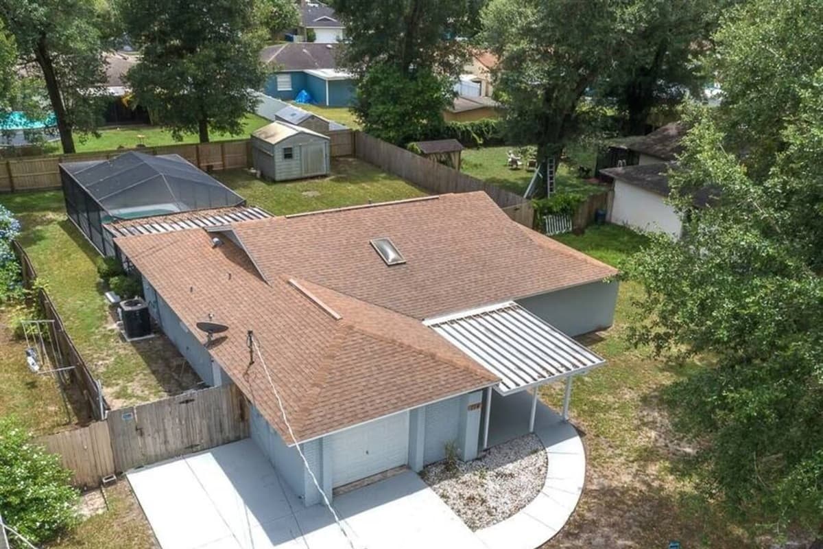 Aerial front view of our lovely property showcasing our beautiful, spacious driveway and our fully fenced backyard where kids can safely play and run around. If you are interested in this property, send us an inquiry now!