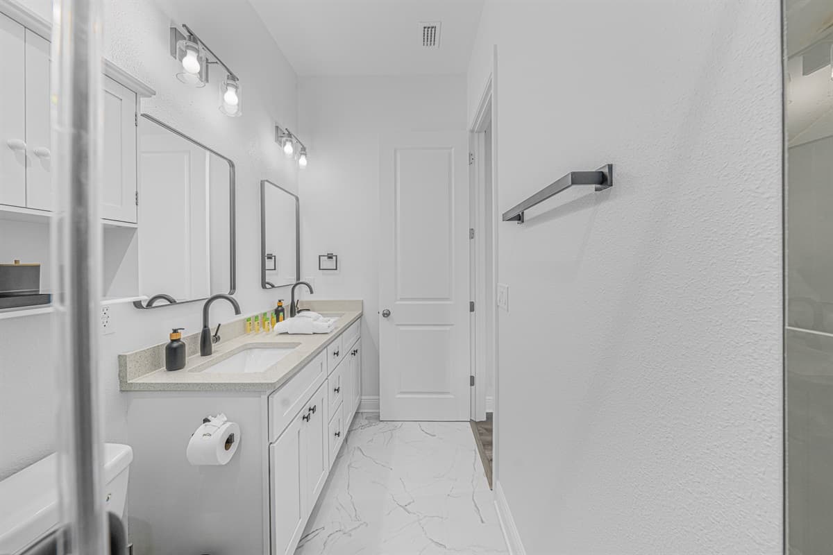 Bright bathroom with extended vanity space, clean lines, and ample lighting.