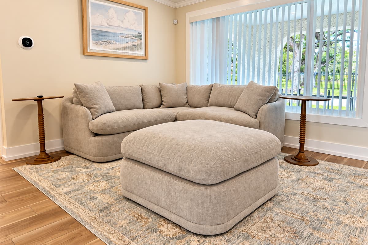 Front living room with sectional seating, TV and fireplace feature.