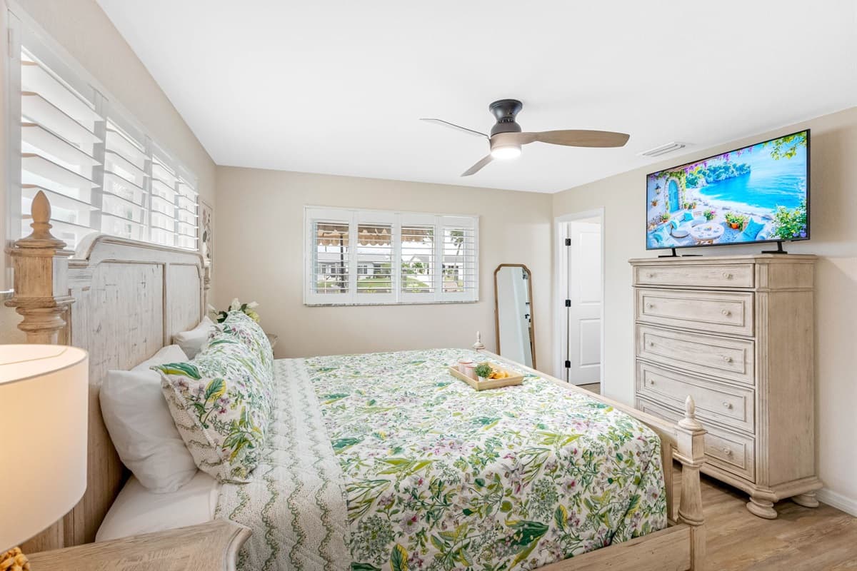 With its ensuite bath, TV, and comfortable seating, this bedroom is a true private retreat within the home.