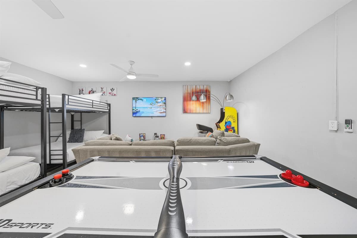 Spacious recreation room with bunk beds, games, and entertainment for guests of all ages.
