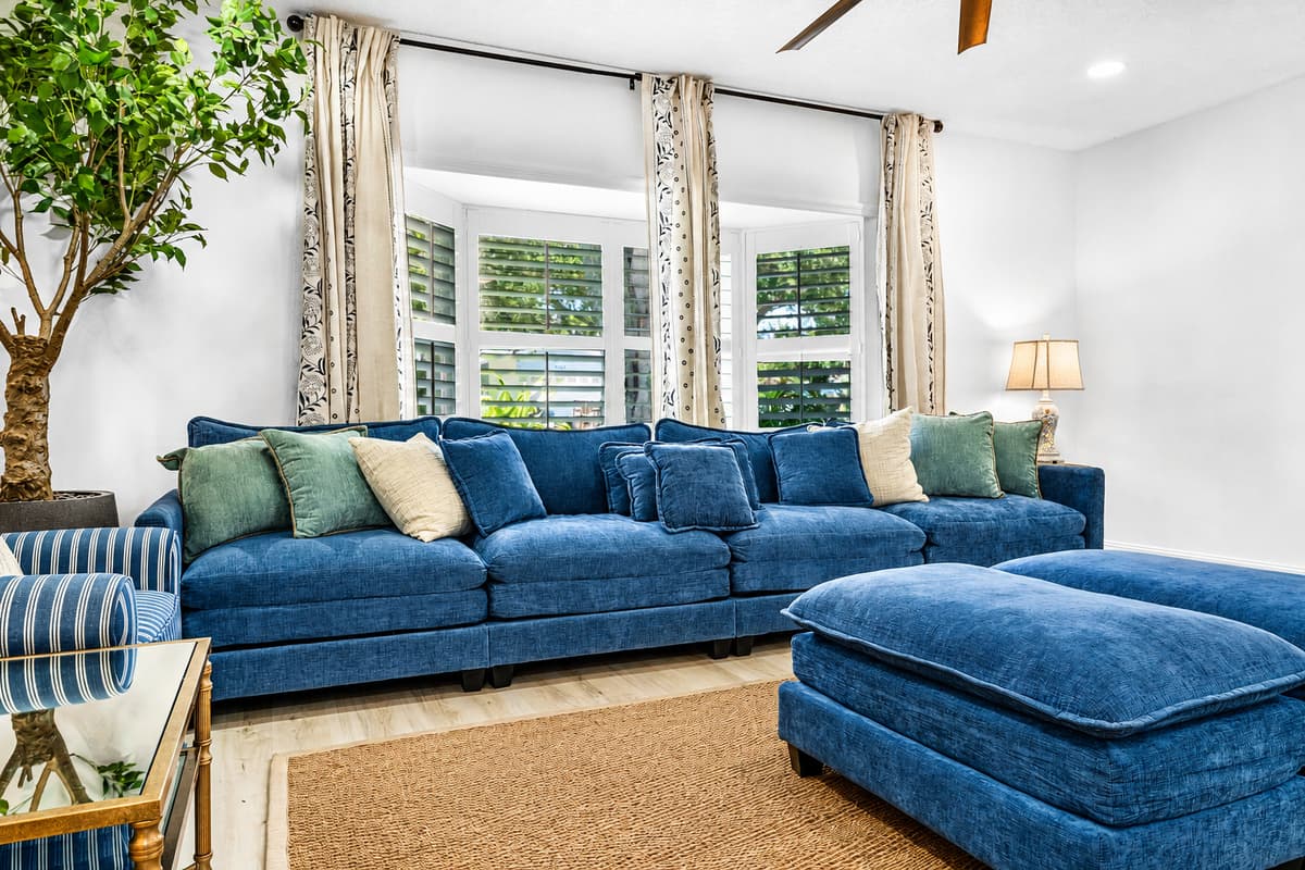 Jute rug, plantation shutters, and a sectional built for people who actually sit in it. No showroom furniture here.