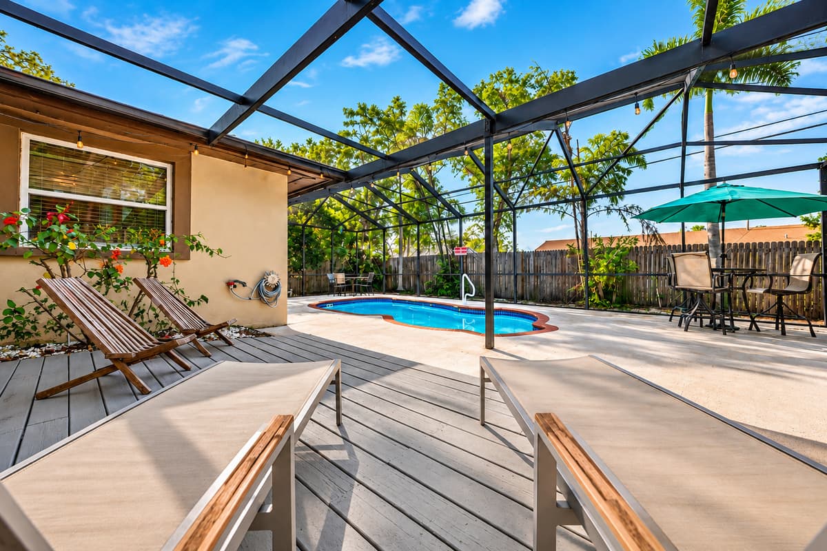Expansive pool deck with lounge chairs, outdoor dining, and plenty of room to relax and unwind.