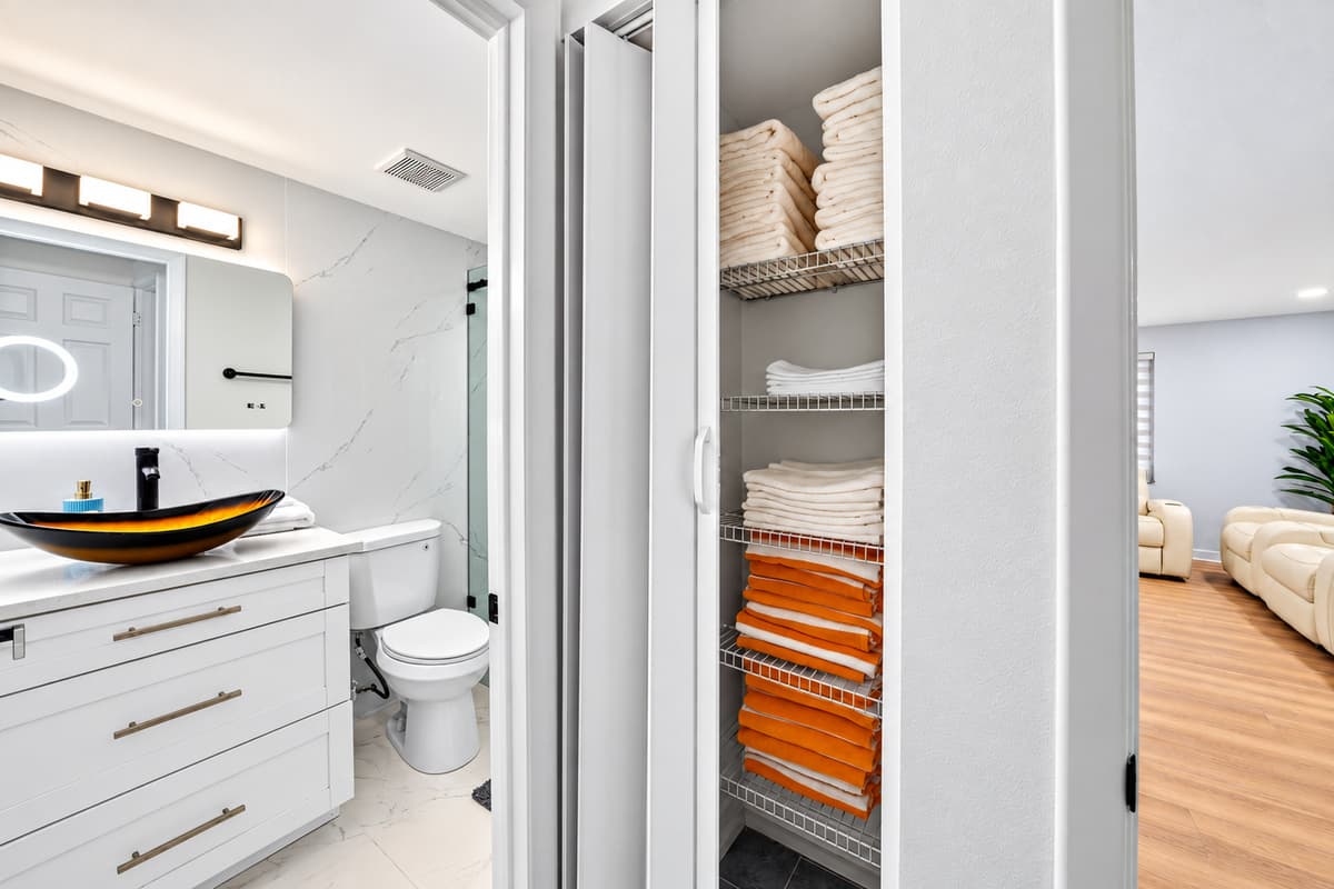Bedroom 1 - Ensuite
Spacious primary ensuite bathroom featuring a modern vanity, fresh towels, and convenient storage for guest essentials.