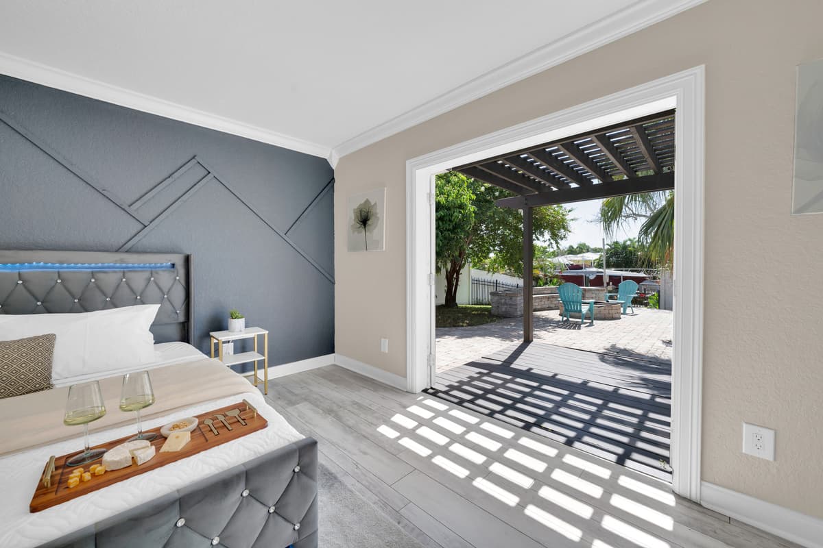 Step right from the bedroom through French doors onto the pergola-covered patio, with the pool just steps away