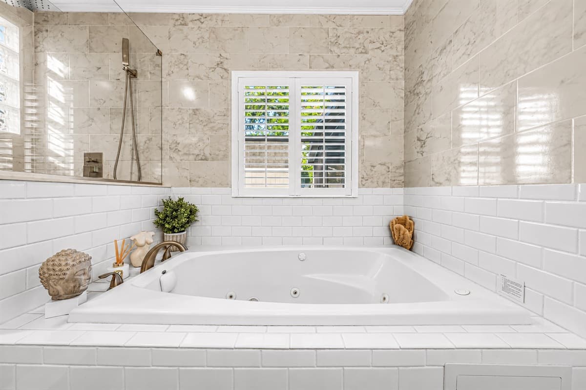 Relaxing soaking tub in the spa-inspired bathroom — perfect for unwinding after a long day.