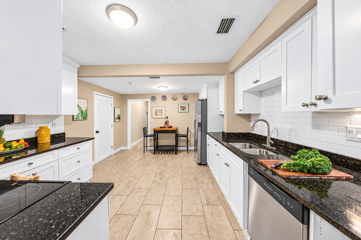Spacious galley-style kitchen with extended countertops and easy access to dining area.