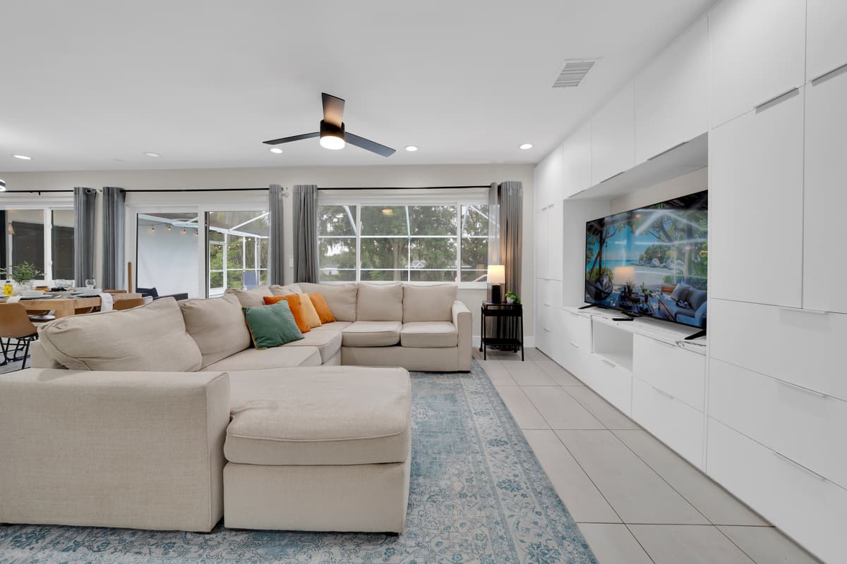 A spacious sofa facing the big screen, ready for movie nights, game days, and unforgettable evenings together!