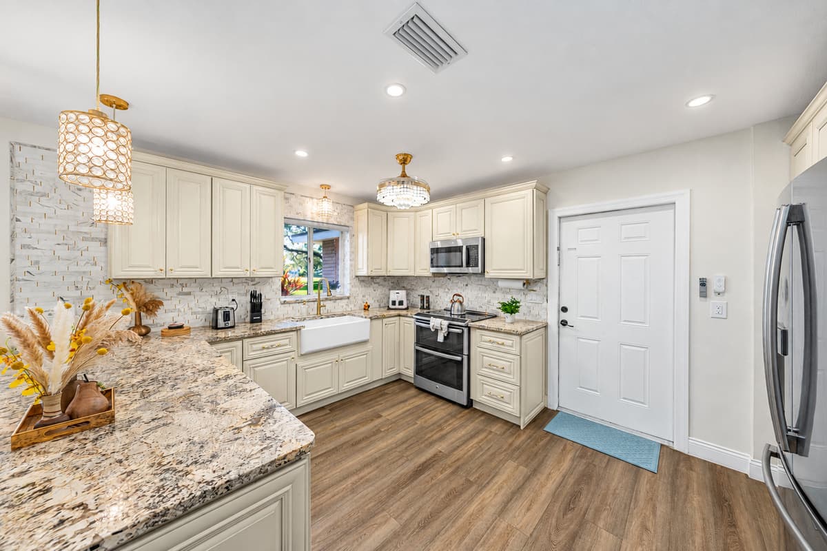 This beautifully designed kitchen blends classic charm with modern convenience, offering ample counter space and an open layout ideal for group meals.