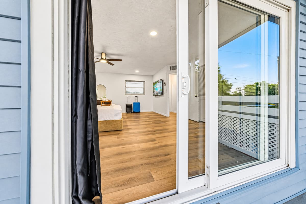 View from inside the bedroom looking out to the private balcony—seamless indoor-outdoor living 