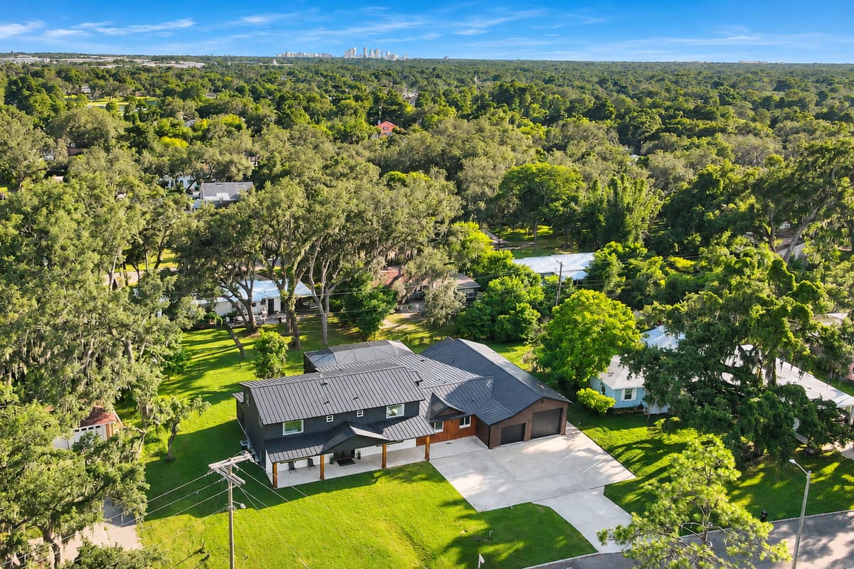 A quiet street, a deep lot, and old Florida oaks. Set back from the road with trees on every side — this is the residential Tampa most visitors never actually see.