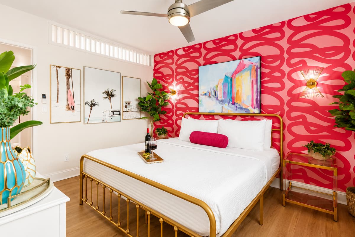 Relax in the stylish king bedroom featuring vibrant coastal décor, a Smart TV, and plenty of room to unwind after a day at the beach.
