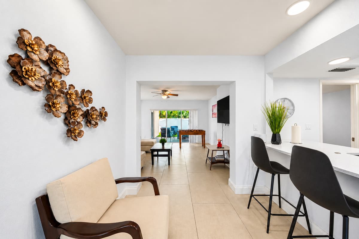 Kitchen area with breakfast bar seating and open-concept layout connecting to the living spaces.