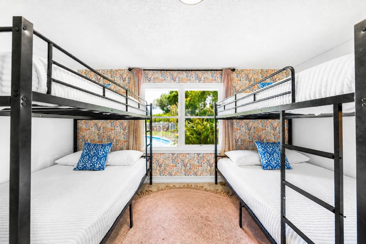 Real mattresses, real dresser, real closet space — bunk room, not an afterthought.