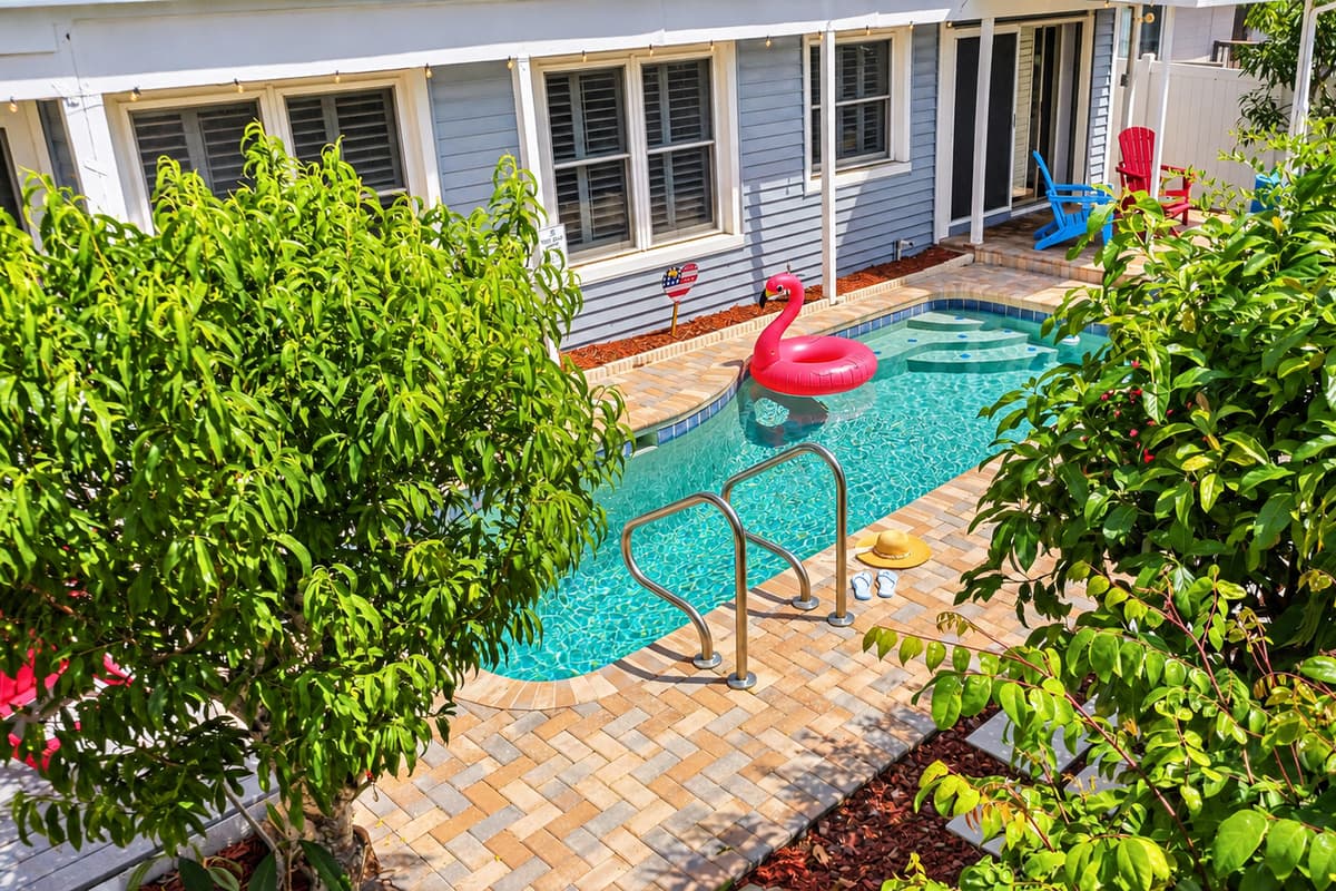 Poolside view framed by tropical landscaping, creating a peaceful and private oasis 