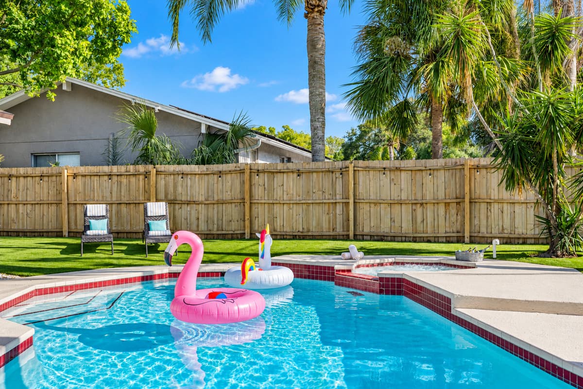The poolside ambiance is enhanced by the soft sound of water cascading from a nearby fountain, adding to the peaceful environment.