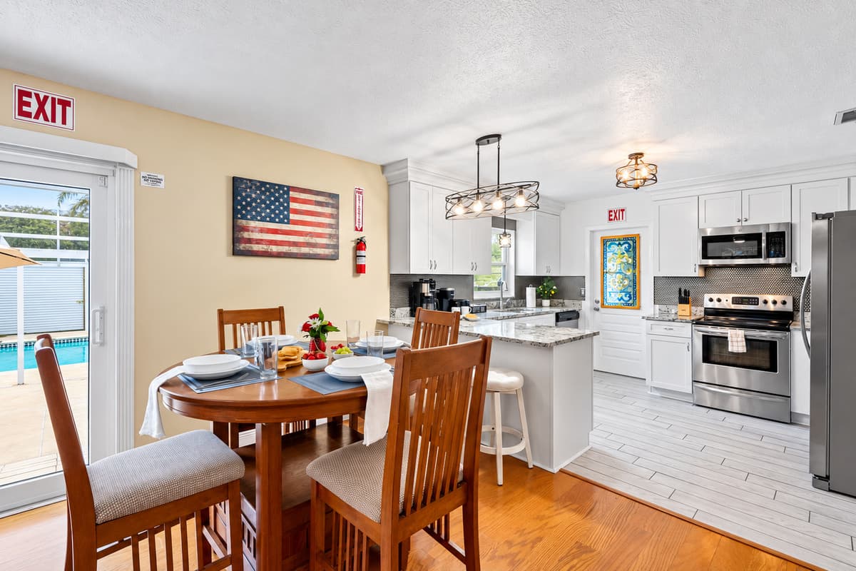 Enjoy meals at the dining table with a seamless view into the living room and outdoor patio.